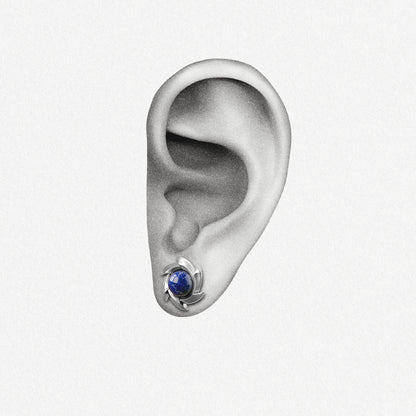 Silver Stellar Nova ear stud with blue center shown on an ear illustration