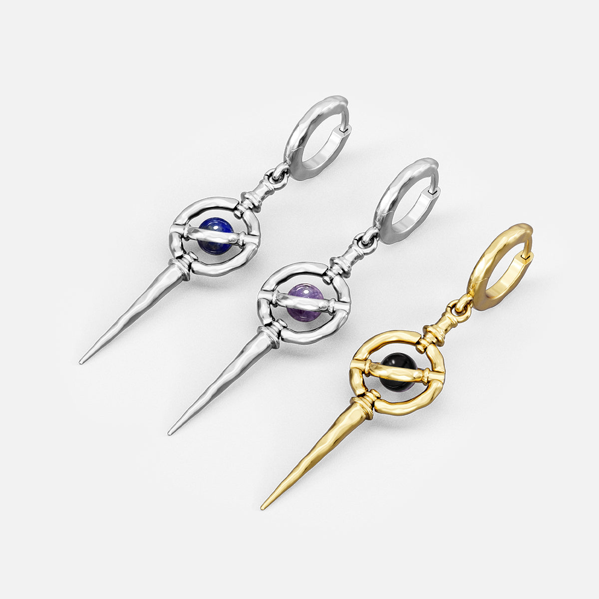 Silver and gold Stellar Orbit drop earrings with blue, purple, and black centers
