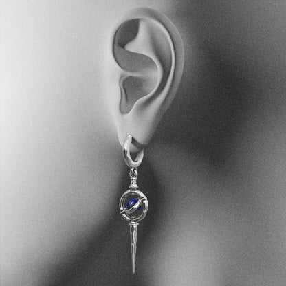 Silver Stellar Orbit earring with blue center shown on an ear illustration