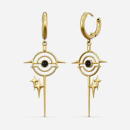 Gold-tone drop earrings with a star burst circle design and black stone center, front view pair