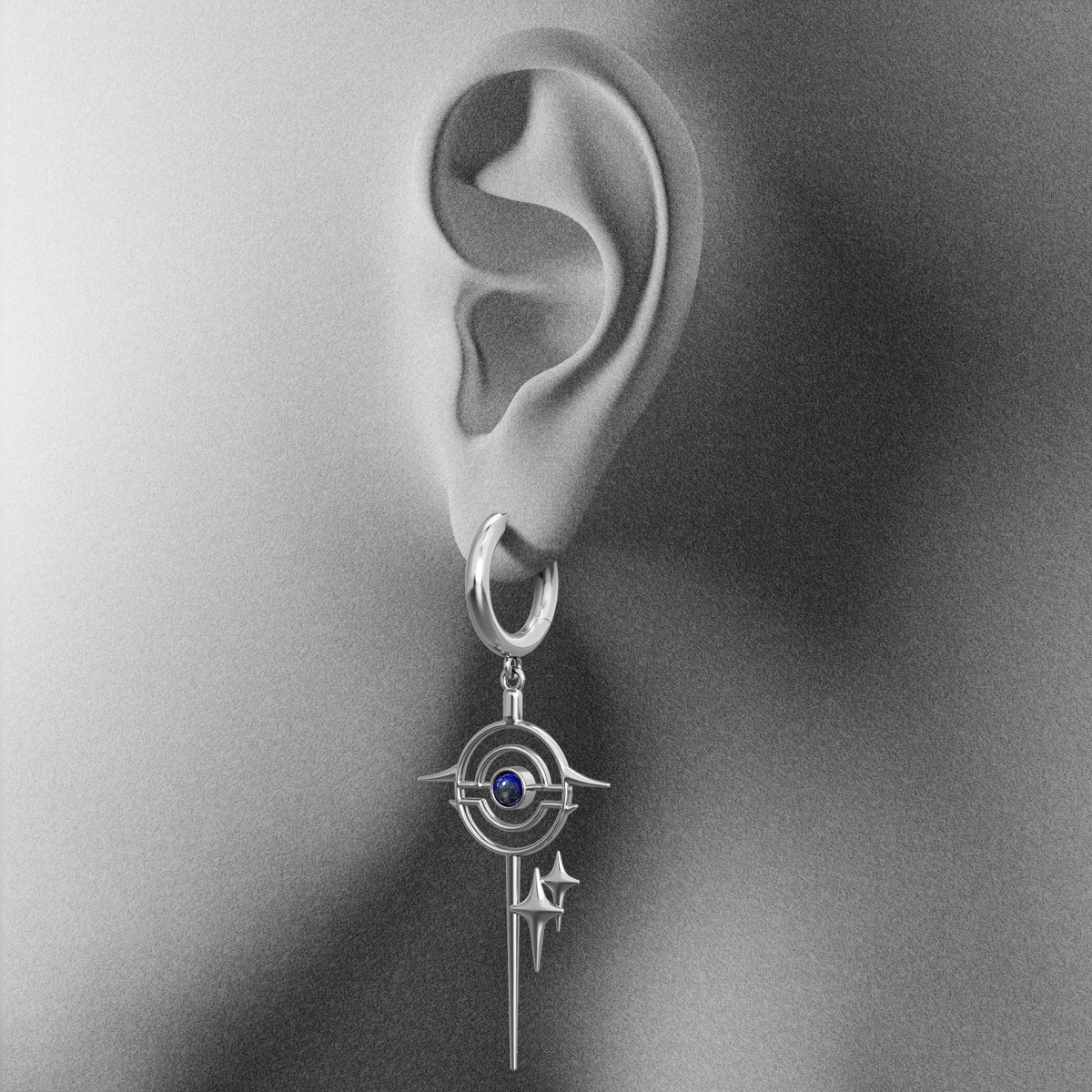 Silver Stellar Path hoop earring with blue center shown on an ear illustration