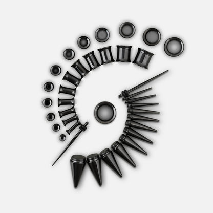 Black ear stretching kit with tapers, tunnels and plugs arranged in a spiral pattern