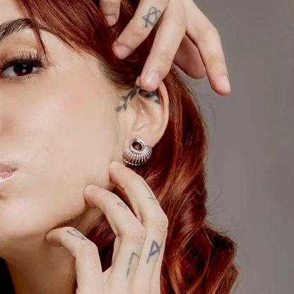 Red-haired model wearing a silver Symmetrical Radiance tunnel