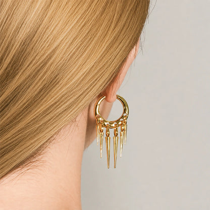 Gold-tone Tapered Chic hoop earring worn on an earlobe, showing five slim pointed drops