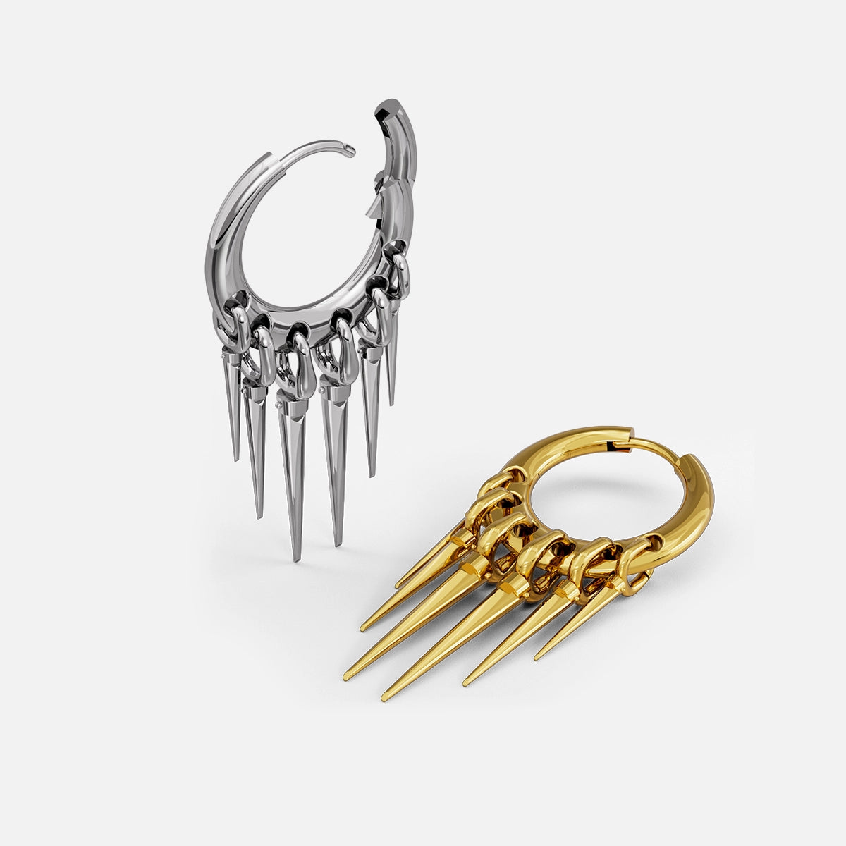 Silver and gold-tone Tapered Chic hoop earrings arranged upright and flat to show the five spike drops