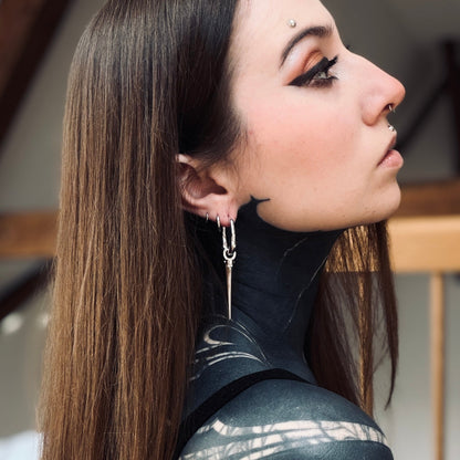 Model wearing a long silver Tapered Edge drop earring