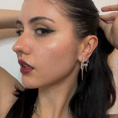 Silver-tone tapered edge earring paired with a small star charm on a hoop, close-up side profile view