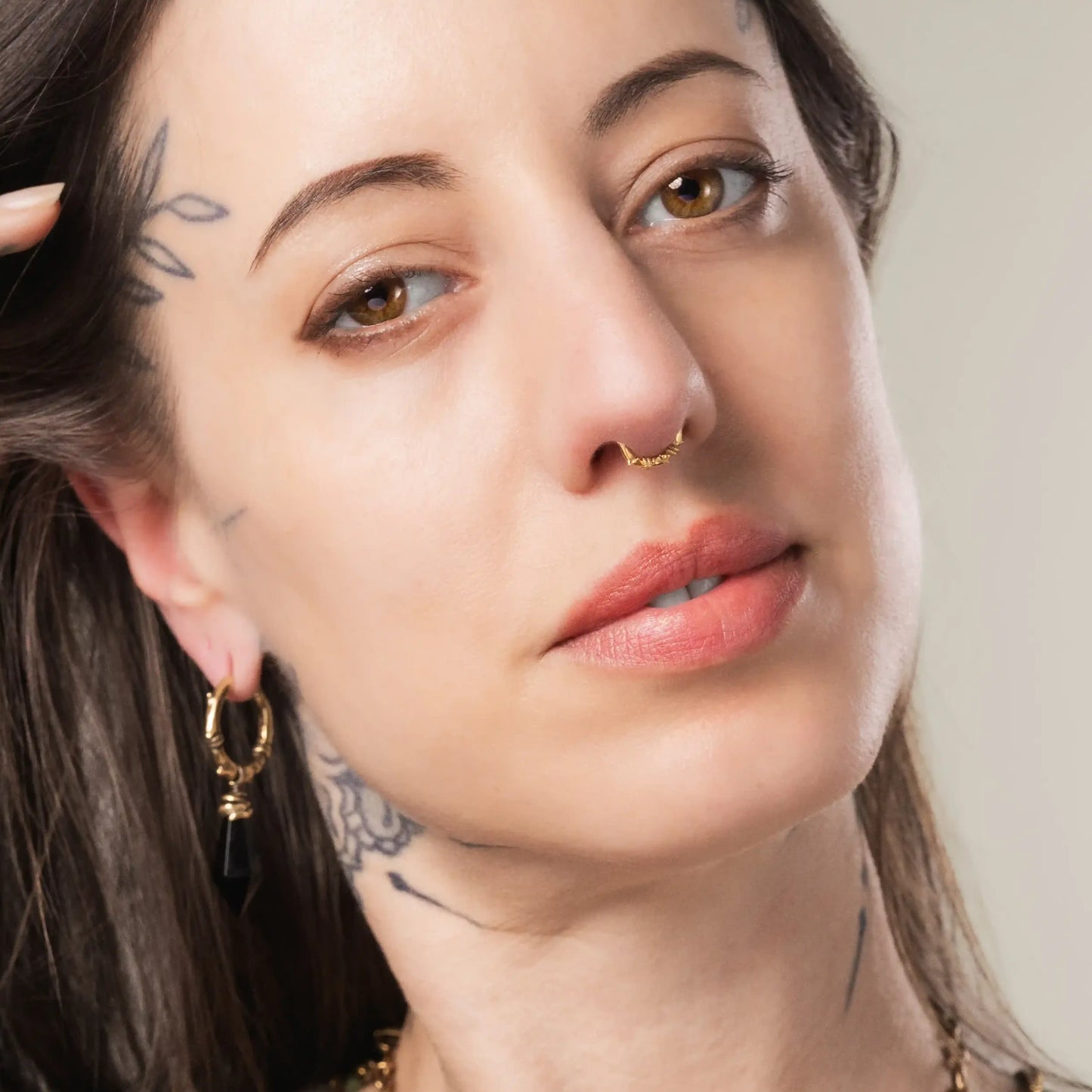 Model wearing gold Thorn Bramble Clicker with gothic woodland jewelry styling