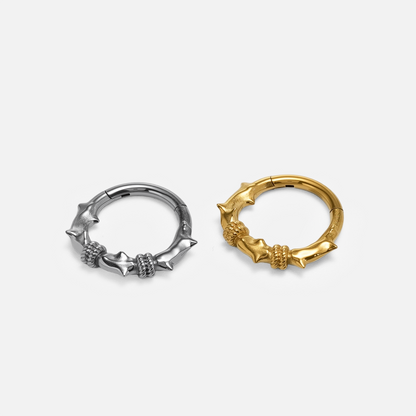 Thorn Bramble Clicker shown in polished titanium and 18K gold PVD finish