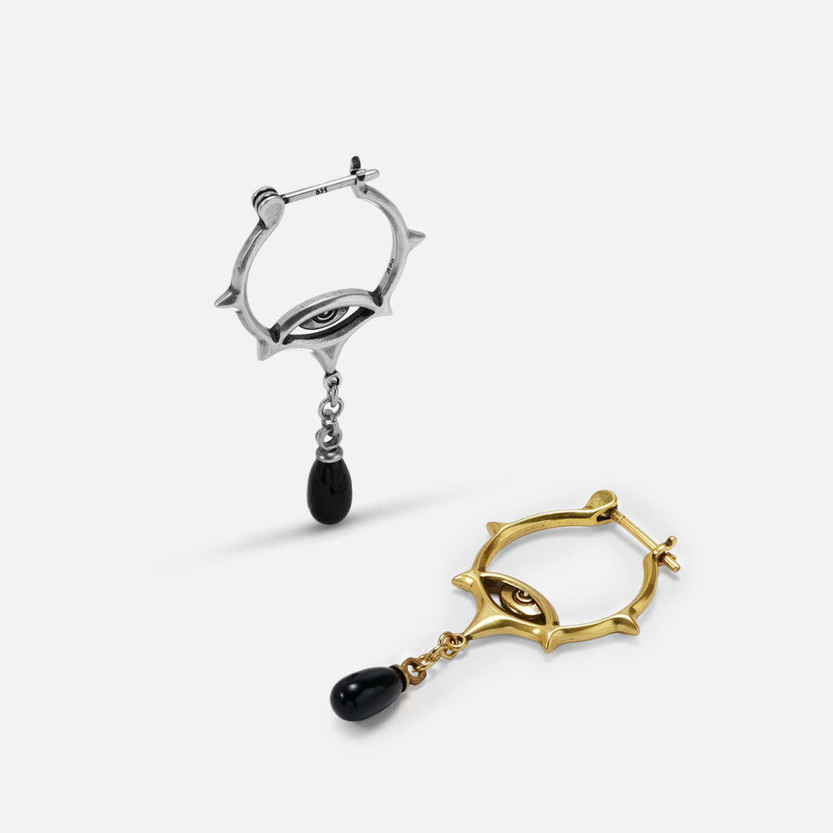Antiqued silver- and gold-tone Thorned Gaze Hoop Earrings displayed from angled views to show the thorned frames and black drops.