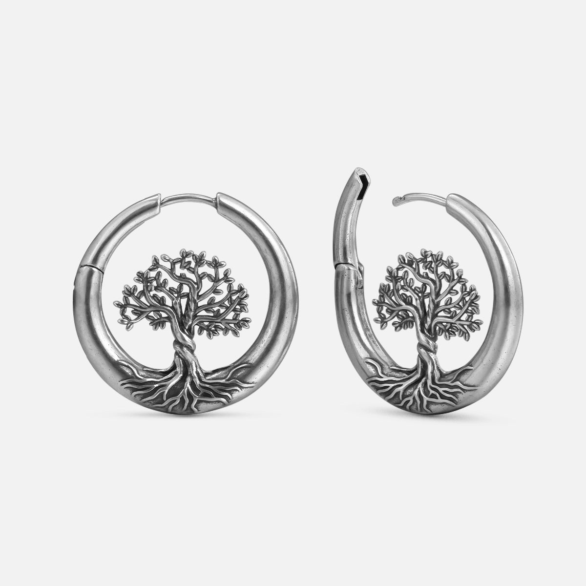Silver-tone hoop earrings with tree of life design shown in front and side views