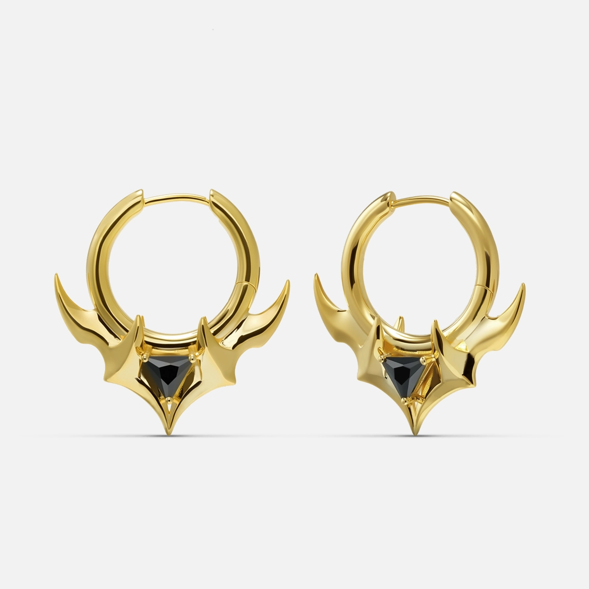 Pair of gold Trident Crest stone hoop earrings with black center accents