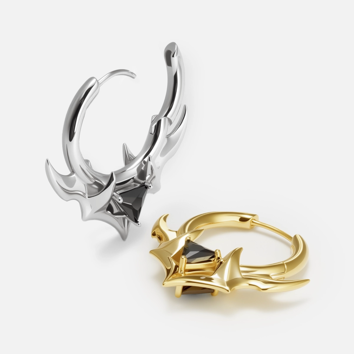 Silver and gold Trident Crest stone hoop earrings shown open and lying flat
