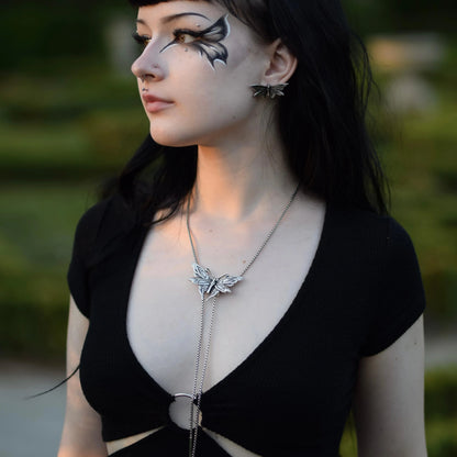 Model wearing Twilight Moth Necklace outdoors with silver moth pendant and gothic jewelry styling