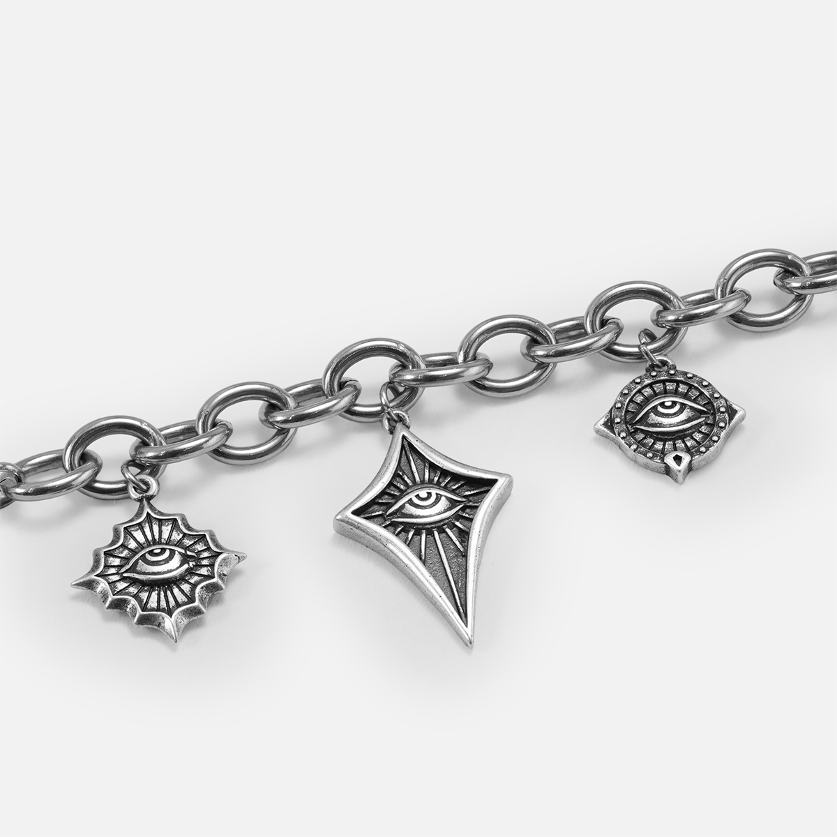 Close-up of the antiqued silver-tone Unblinking Procession Bracelet showing the substantial links and sculpted eye charms.