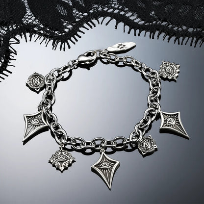 Antiqued silver-tone Unblinking Procession Bracelet displayed in a circular arrangement against black lace on a dark reflective surface.