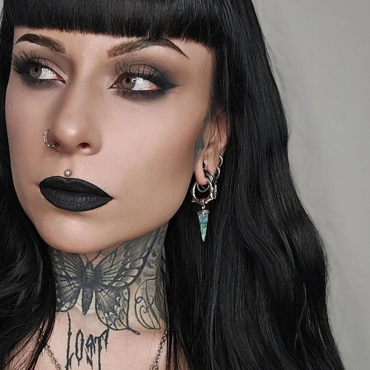 Unearthed Spike Earrings in 925 sterling silver, worn in a gothic portrait with black hair, black lipstick, and extensive nec