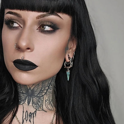 Unearthed Spike Earrings in 925 sterling silver, worn in a gothic portrait with black hair, black lipstick, and extensive nec