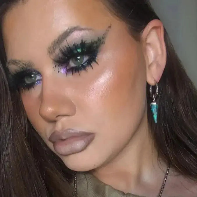 Unearthed Spike Earrings in 925 sterling silver, worn in a close portrait with dramatic green eye makeup and the turquoise sp