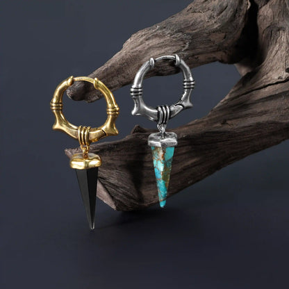 Unearthed Spike Earrings in silver and gold displayed on driftwood with turquoise and obsidian stone options