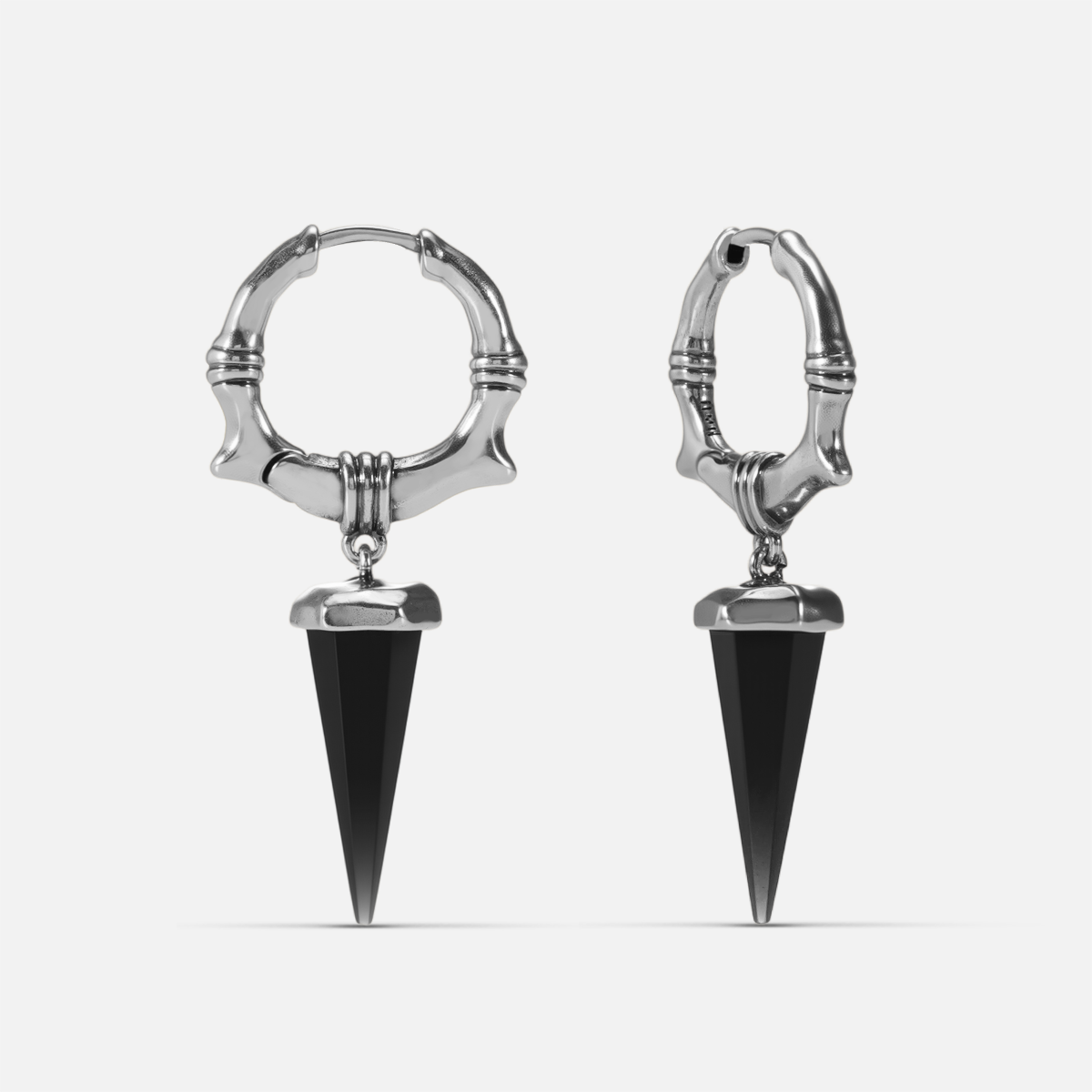 Silver Unearthed Spike Earrings with black obsidian spike drops, bone-textured hoops, and bound relic details on a clean background.