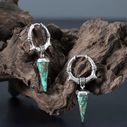 Silver Unearthed Spike Earrings displayed on weathered wood with turquoise spike pendants