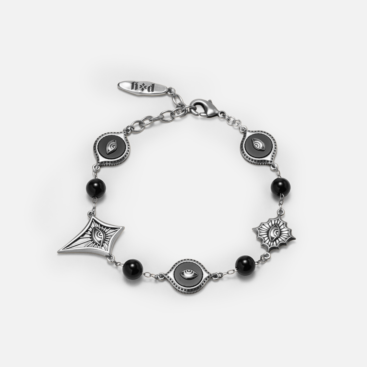 Antiqued silver-tone Unseen Orbit Bracelet with black obsidian beads, eye-shaped links, and sculpted eye medallions in pointed frames.