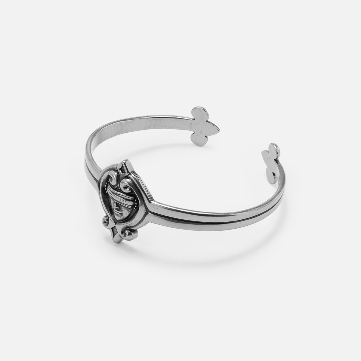 Antiqued silver-tone Veiled Seer Cuff Bracelet displayed from an angled view to show the open band and raised centerpiece.