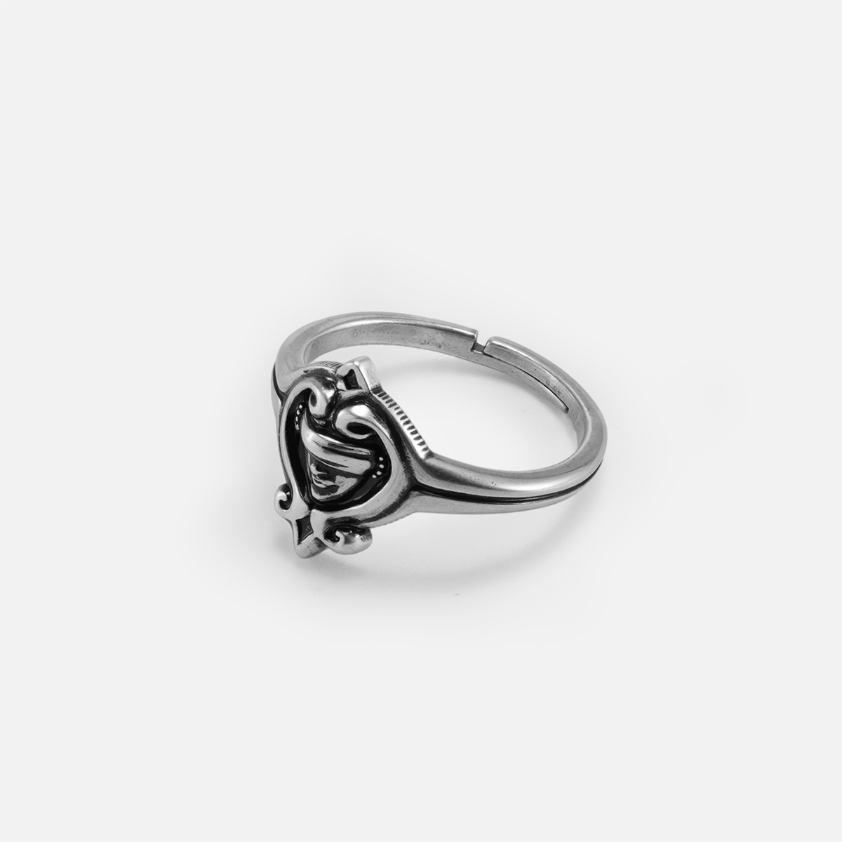 Side view of the antiqued silver Veiled Seer Ring showing the raised ornamental setting and adjustable open band.