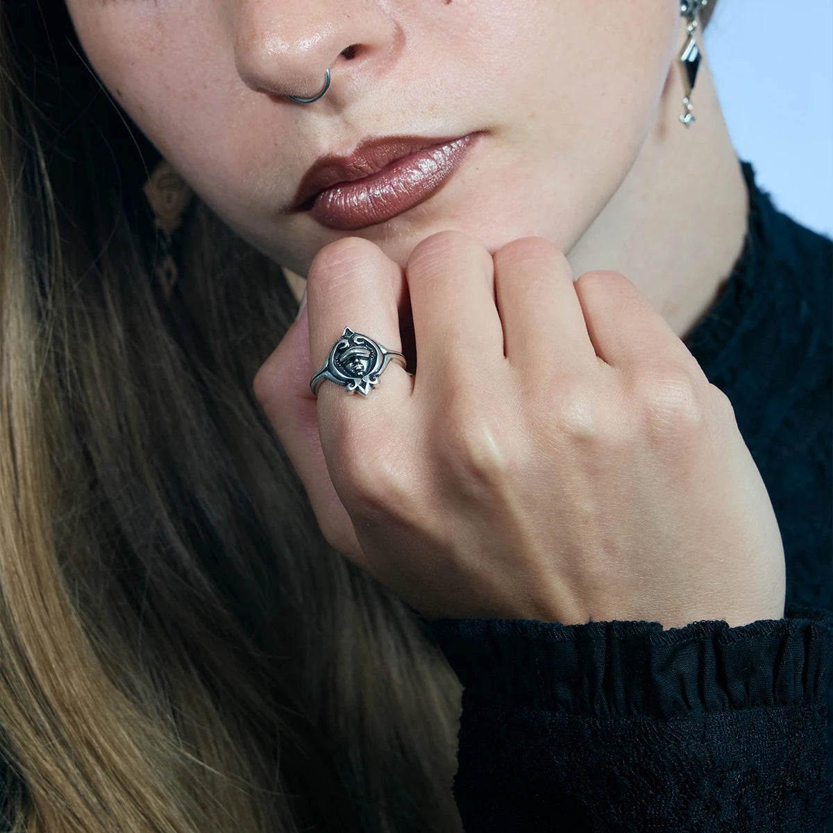 Antiqued silver Veiled Seer Ring worn in a downward-looking portrait with the pointed centerpiece facing outward.