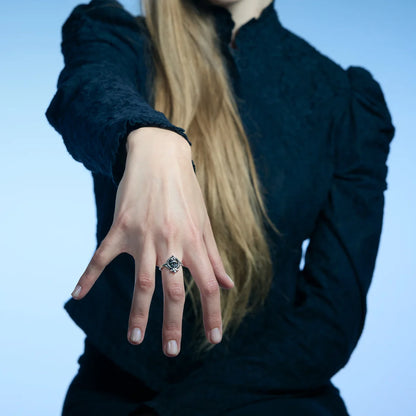Antiqued silver Veiled Seer Ring worn on an extended hand, showing its compact pointed centerpiece and open band.