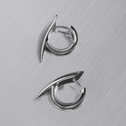 Venom Claw Earrings in 925 sterling silver, pair arranged on brushed metal to show the curved claw form from above.