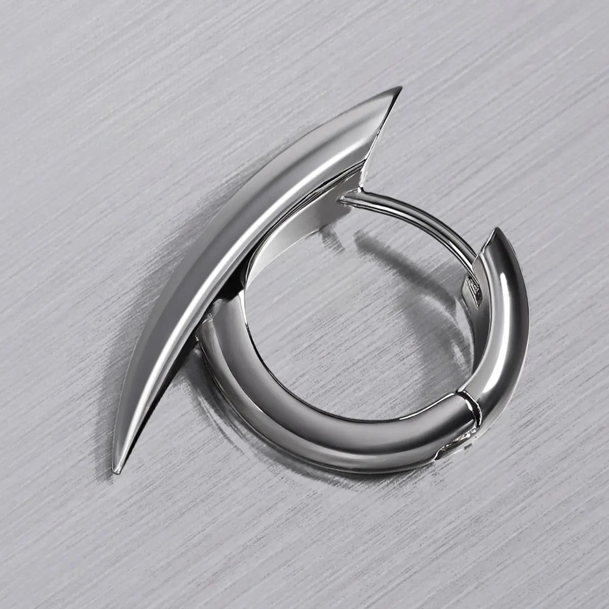 Venom Claw Earrings in 925 sterling silver, single claw hoop shown in close product detail on brushed metal.