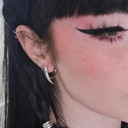 Silver Venom Claw Earrings styled on model with sharp claw hoop silhouette