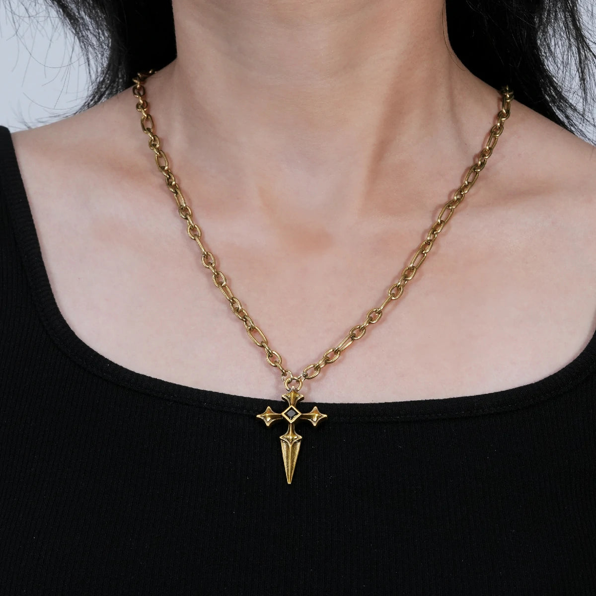 Vesper Blade Necklace in antiqued 18K gold worn at the collarbone over a black top in a front styling view.
