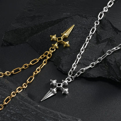 Silver and gold Vesper Blade Necklaces laid diagonally together on black textured fabric.