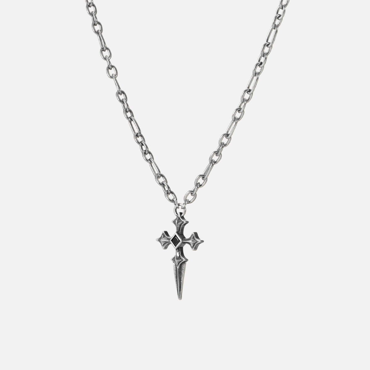 Vesper Blade Necklace in silver shown vertically on white, highlighting the blade-shaped cross pendant and chain detail.