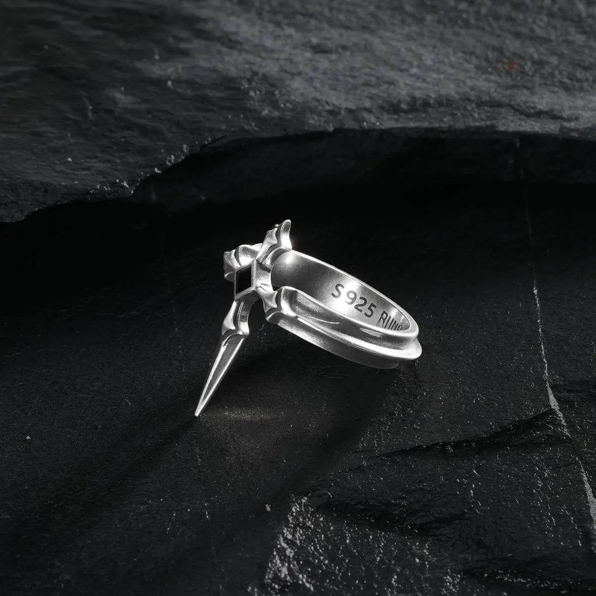 Vesper Blade Ring in silver shown at an angled side view on black textured fabric.