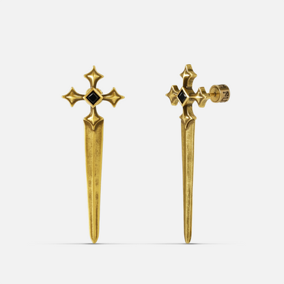Vesper Blade Stud Earrings in antiqued 18K gold with blade-shaped cross design and black obsidian, shown as a pair on white.