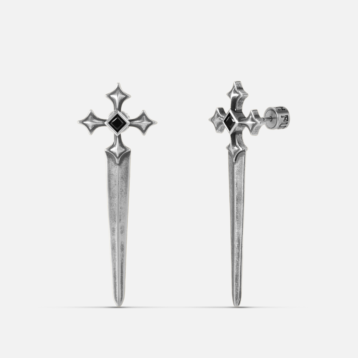 Vesper Blade Stud Earrings in antiqued silver with blade-shaped cross design and black obsidian, shown as a pair on white.