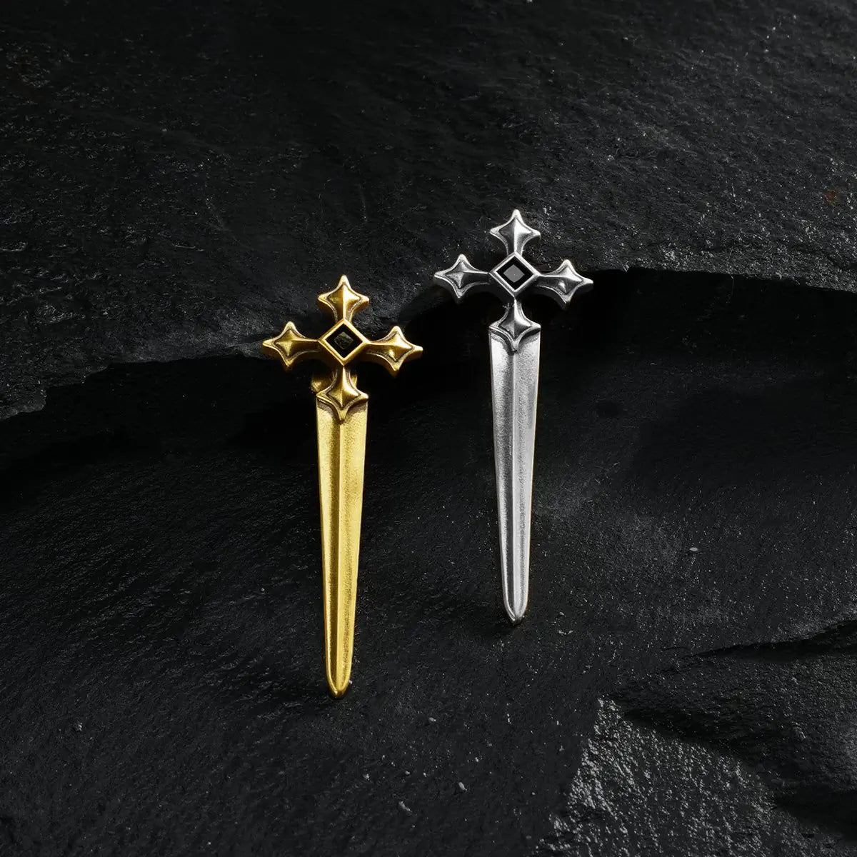 Silver and gold Vesper Blade Stud Earrings displayed together on black textured fabric.