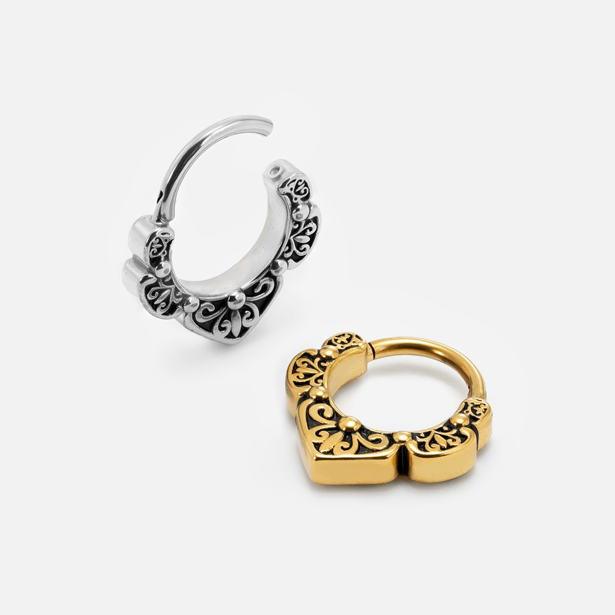 Silver-tone and gold-tone Victorian Bloom clickers shown open at an angle with raised floral details