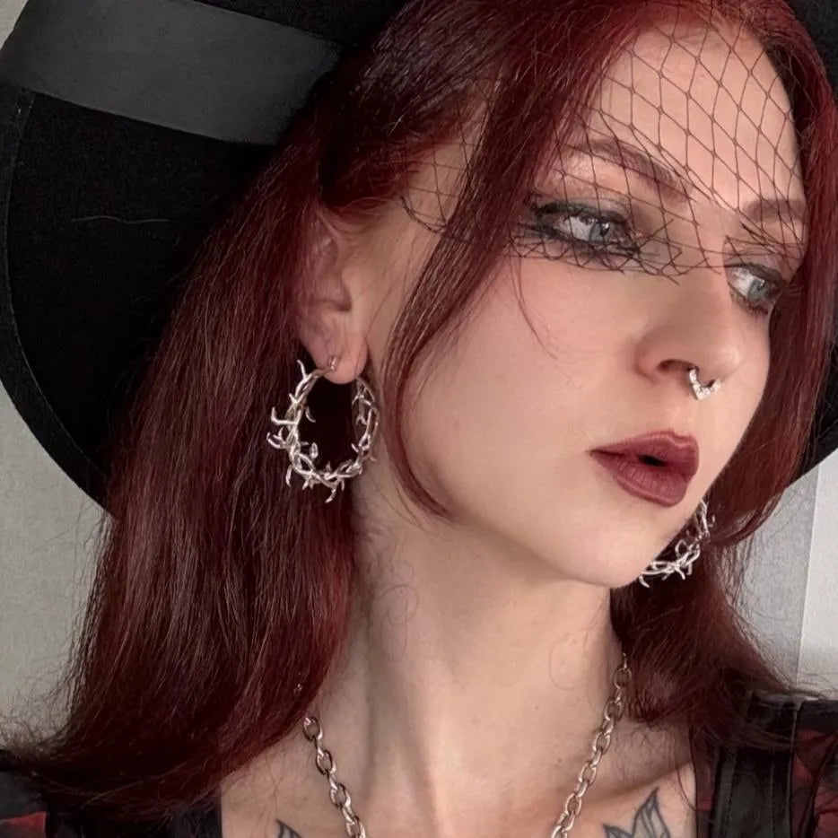 Vine Whispers Earrings styled on model with silver thorn hoops and dark romantic gothic look