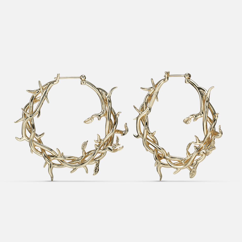 Gold-tone Vine Whispers hoop earrings shaped from twisting thorny branches