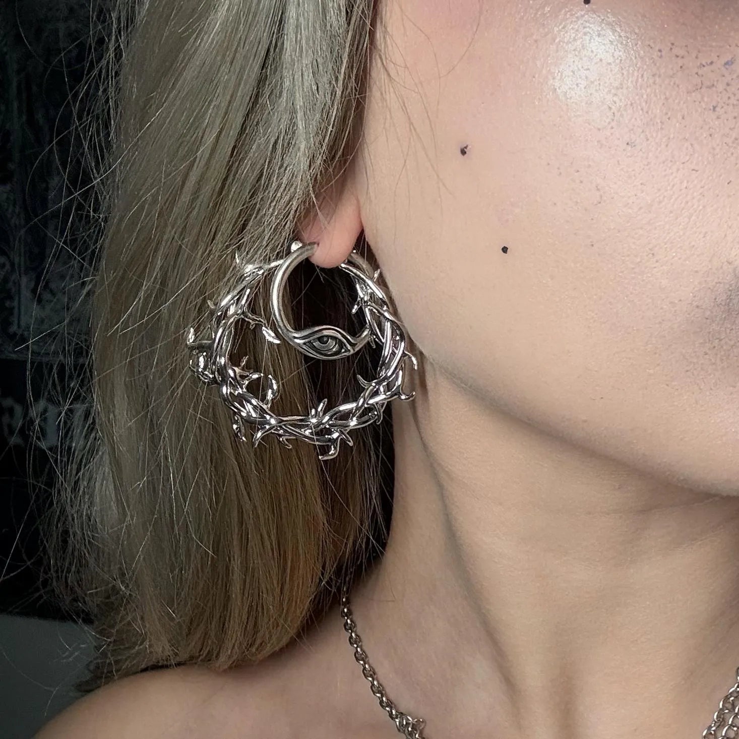Silver Vine Whispers Earrings styled on model with twisted vine hoop, thorn details, and gothic botanical jewelry look