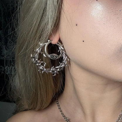 Silver Vine Whispers Earrings styled on model with twisted vine hoop, thorn details, and gothic botanical jewelry look