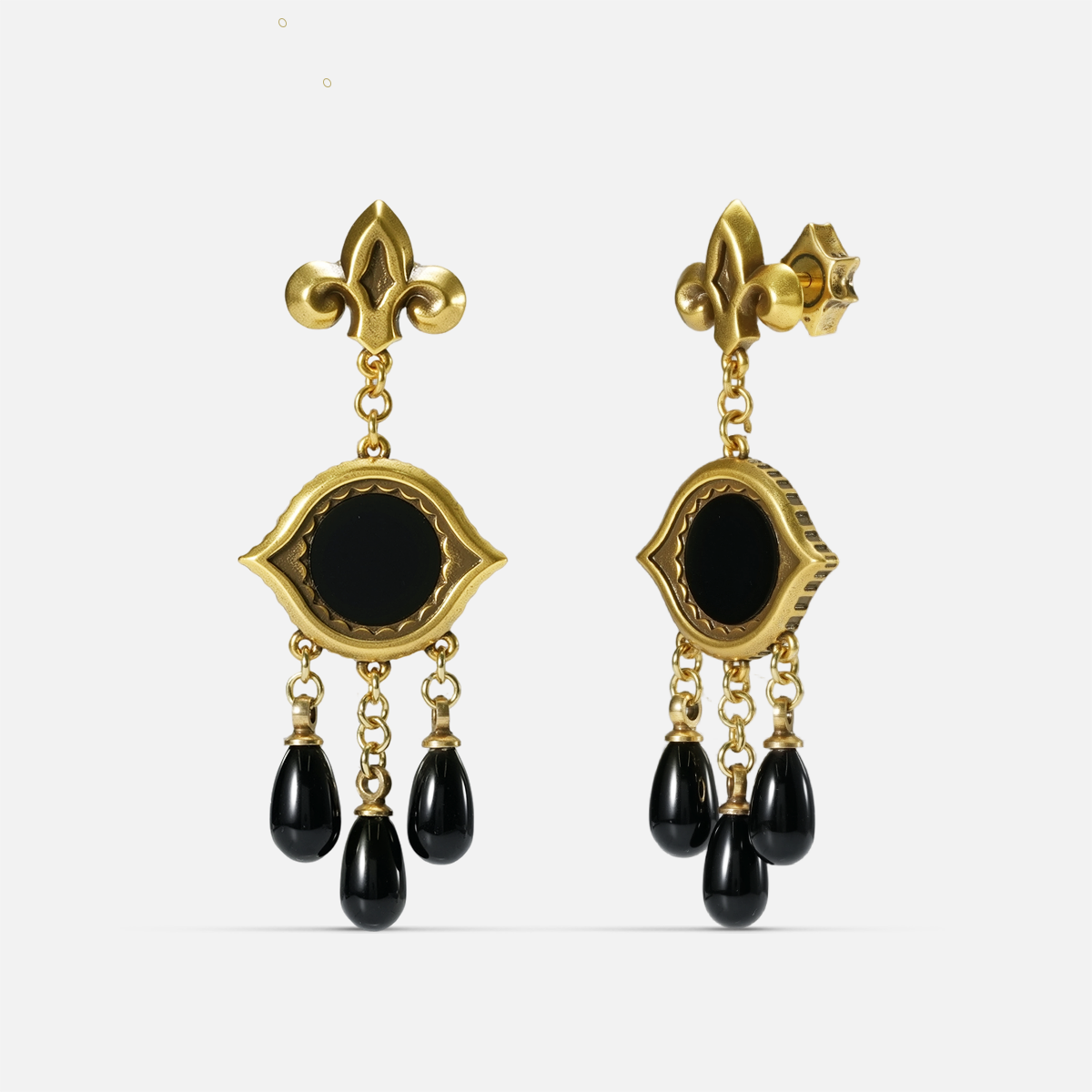 Gold-tone Votive Mirror Earrings shown from front and side views with round black obsidian centers and three suspended black drops.