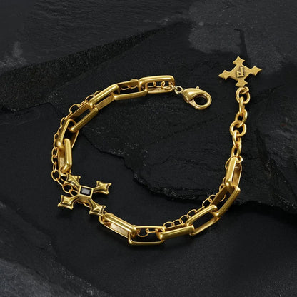 Gold Vowbound Chain Bracelet arranged in a full loop on black textured fabric.