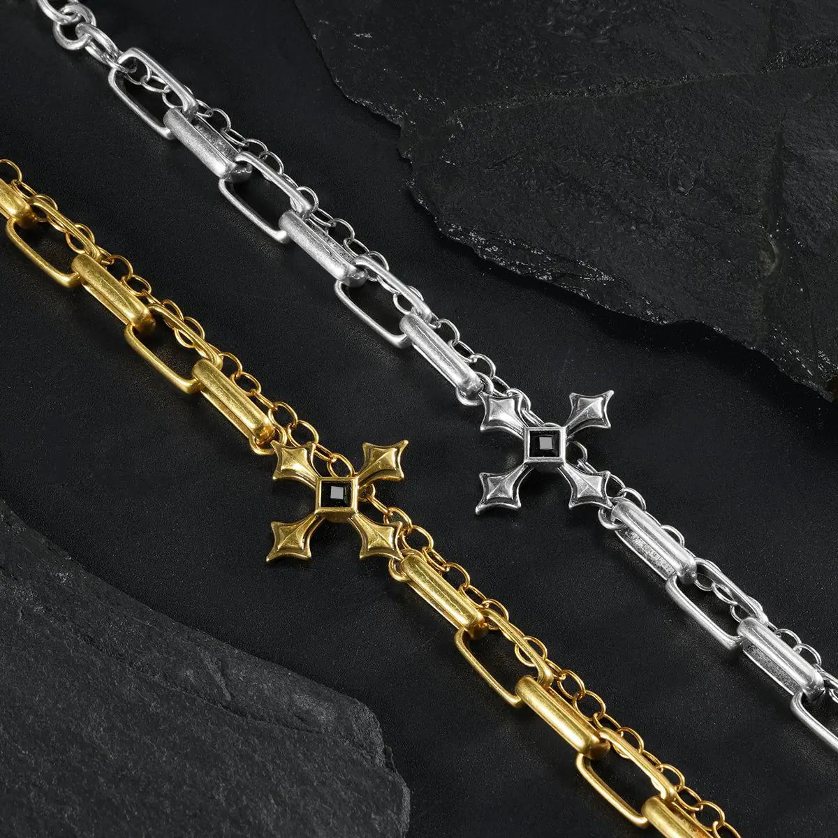 Silver and gold Vowbound Chain Bracelet links shown diagonally on black textured fabric.