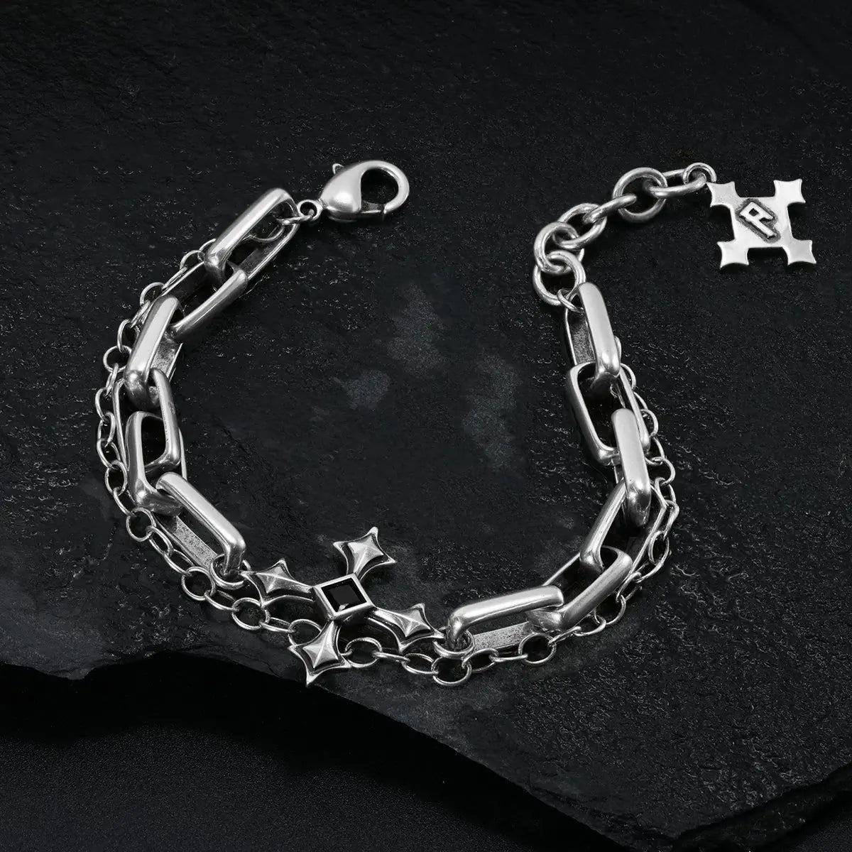 Silver Vowbound Chain Bracelet arranged in a full loop on black textured fabric.